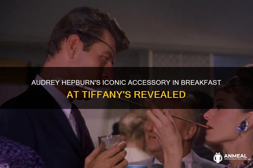 what does audrey hepburn hold in breakfast at tiffanys